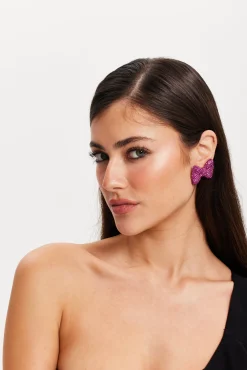 Liquorish Diamonte Bow Stud Earrings In Pink