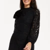Women's Black Lace Mini Dress with Balloon Sleeves and Flower Detail - Elegant, Floral Embellishment, High Neckline.