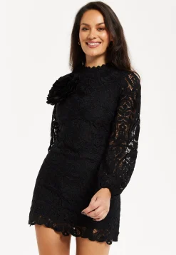Women's Black Lace Mini Dress with Balloon Sleeves and Flower Detail - Elegant, Floral Embellishment, High Neckline.