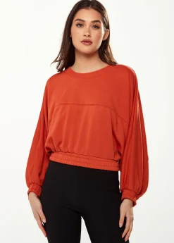 Women's Cropped Sweatshirt in Dark Orange with Voluminous Bat and Balloon Sleeves, Elastic Cuffs, and a Chic Design.