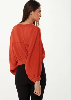 Women's Cropped Sweatshirt in Dark Orange with Voluminous Bat and Balloon Sleeves, Elastic Cuffs, and a Chic Design.