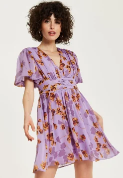 Women's Mini Dress in Purple Floral with Short Sleeves and Deep V Neck - Stylish Button Waistband by Liquorish