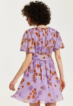 Women's Mini Dress in Purple Floral with Short Sleeves and Deep V Neck - Stylish Button Waistband by Liquorish