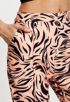 Women's Trousers in Orange and Nude Zebra Print with Slit Detail and Button Closure by Liquorish