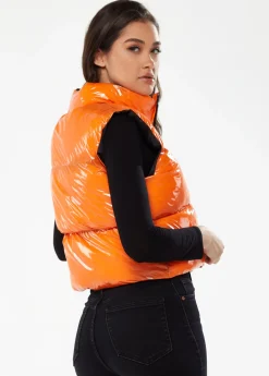 Women's Wet Look Gilet in Orange - Sleeveless, High Neck, Zip Closure, Cropped Fit, Regular Fit, Available in Classic and Bright Colours.