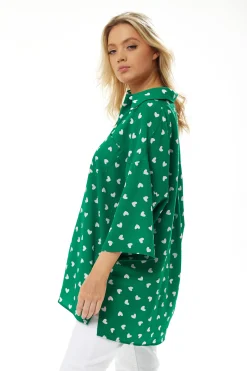 Women's White Heart Print Shirt in Green - Short sleeves, oversized fit, heart-shaped buttons, button-up front, collar.